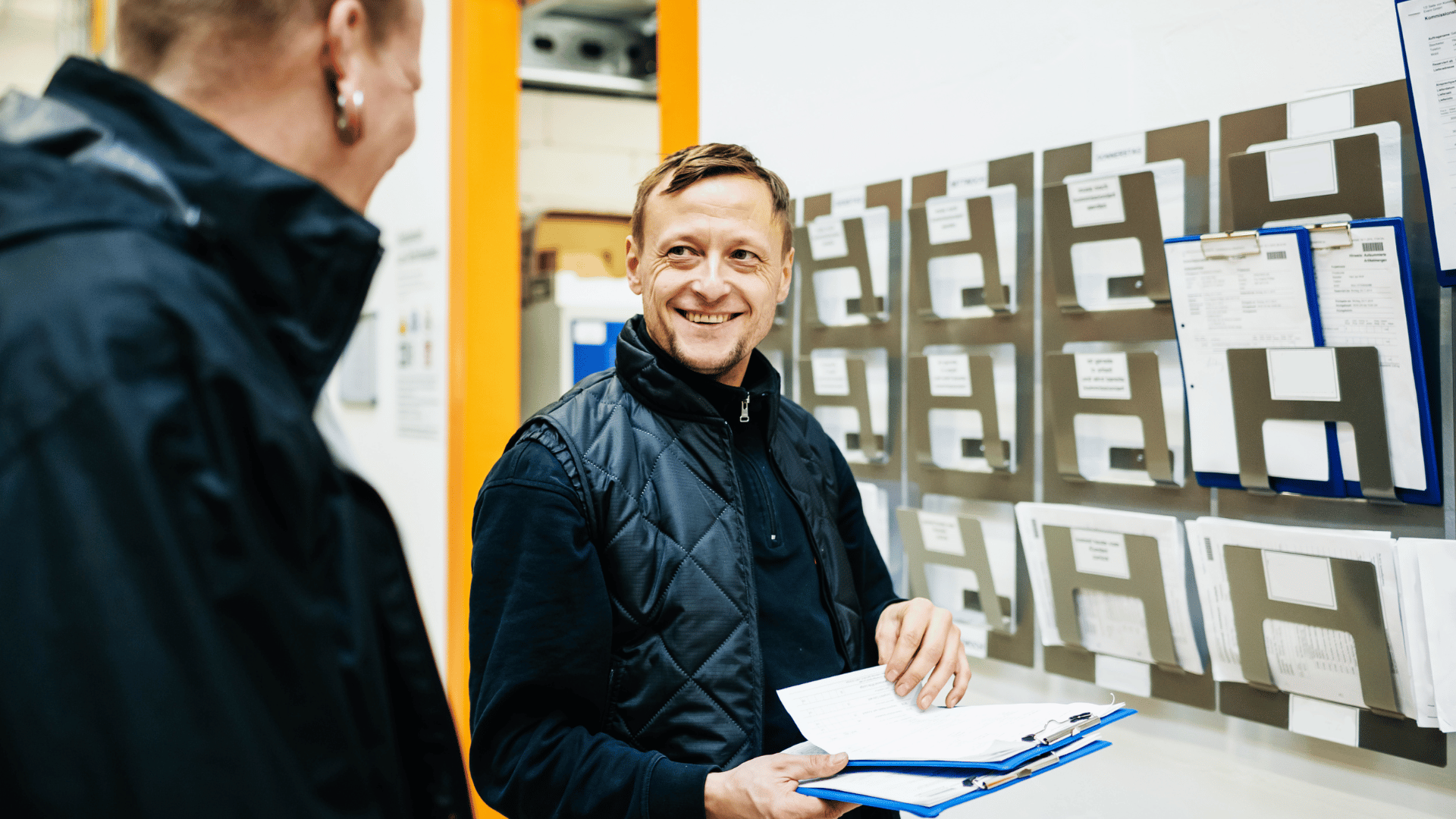 warehouse manager speaking to employee