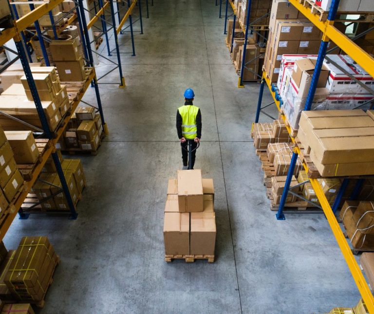 warehouse employee pulling pallet lifter