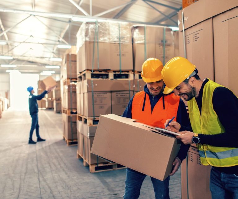 two men signing over goods at warehouse